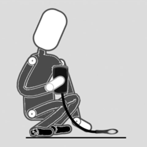 A person kneeling down taking a luminescent measurement with a light meter at ground level