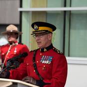 A/Commr. Elija Rain at the podium giving a speech