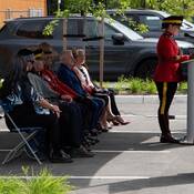 Emcee Staff Sergeant Major Kathleen Darby speaking at the podium